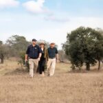 Trails Guide pointing out wildlife signs on foot in the Sabi Sand
